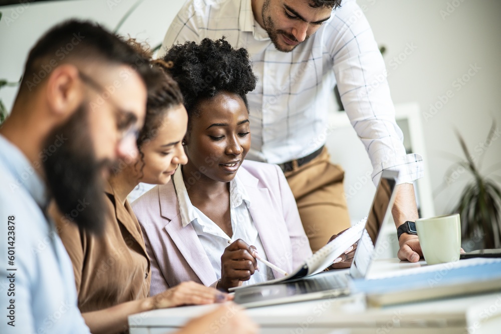 A diverse, casual design team collaborates in the office, creating innovative solutions and fostering in dynamic creative environment.