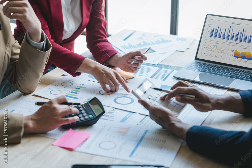 Teamwork of asian business people discussing and calculating with calculator on evaluation data in conference room. with the growth and pointing to the chart graph financial account.