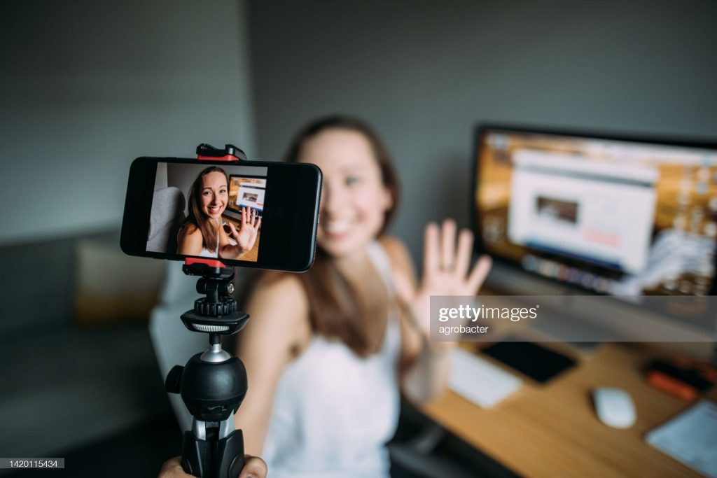 Beautiful woman vlogging at home